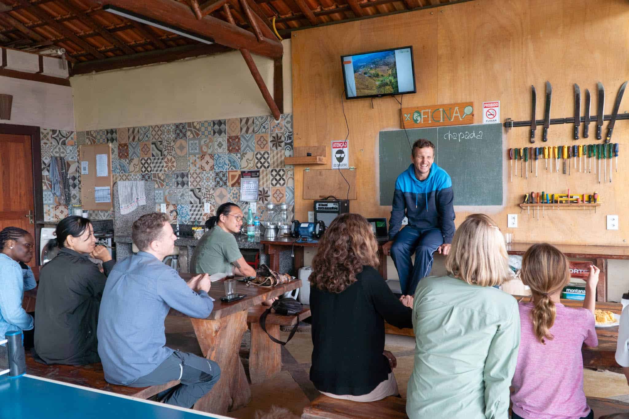 Instructor teaching agroforestry and permaculture principles to international volunteers at an eco farm in Brazil.