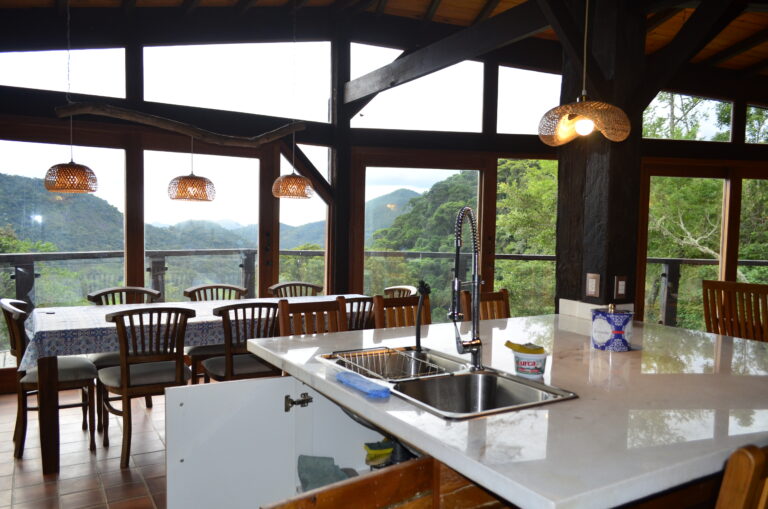 Beautiful sustainable kitchen and dining room with mountain view at an eco farm in Brazil