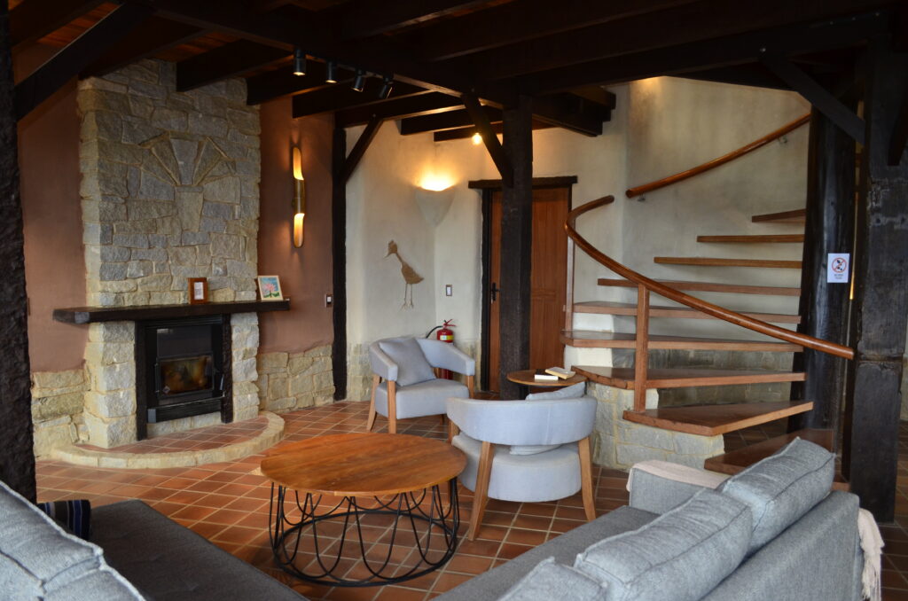 Cozy living room with fireplace inside a bioconstruction house at an eco farm in Brazil