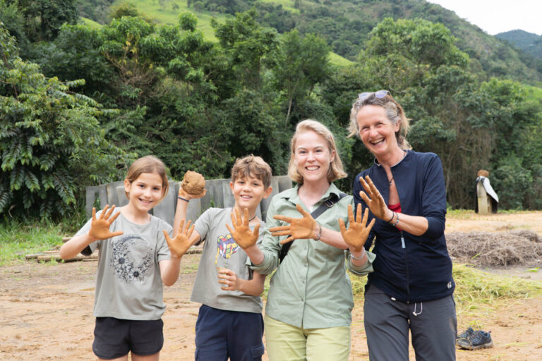 Family participating in a natural building workshop at Eco Caminhos, a permaculture farm in Brazil, using sustainable bioconstruction techniques.