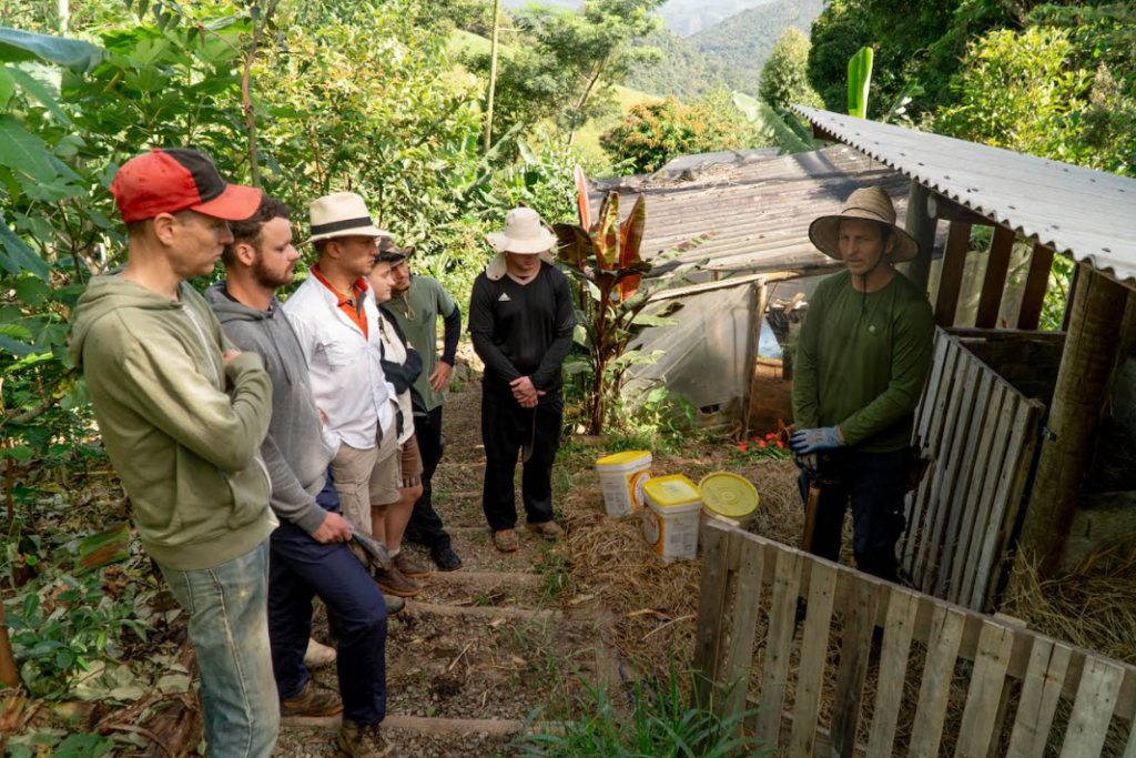Volunteer preparing organic compost on a permaculture farm in Brazil.