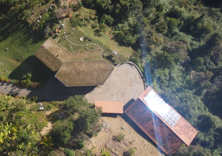 Solar panels installed on a natural building at Eco Caminhos.