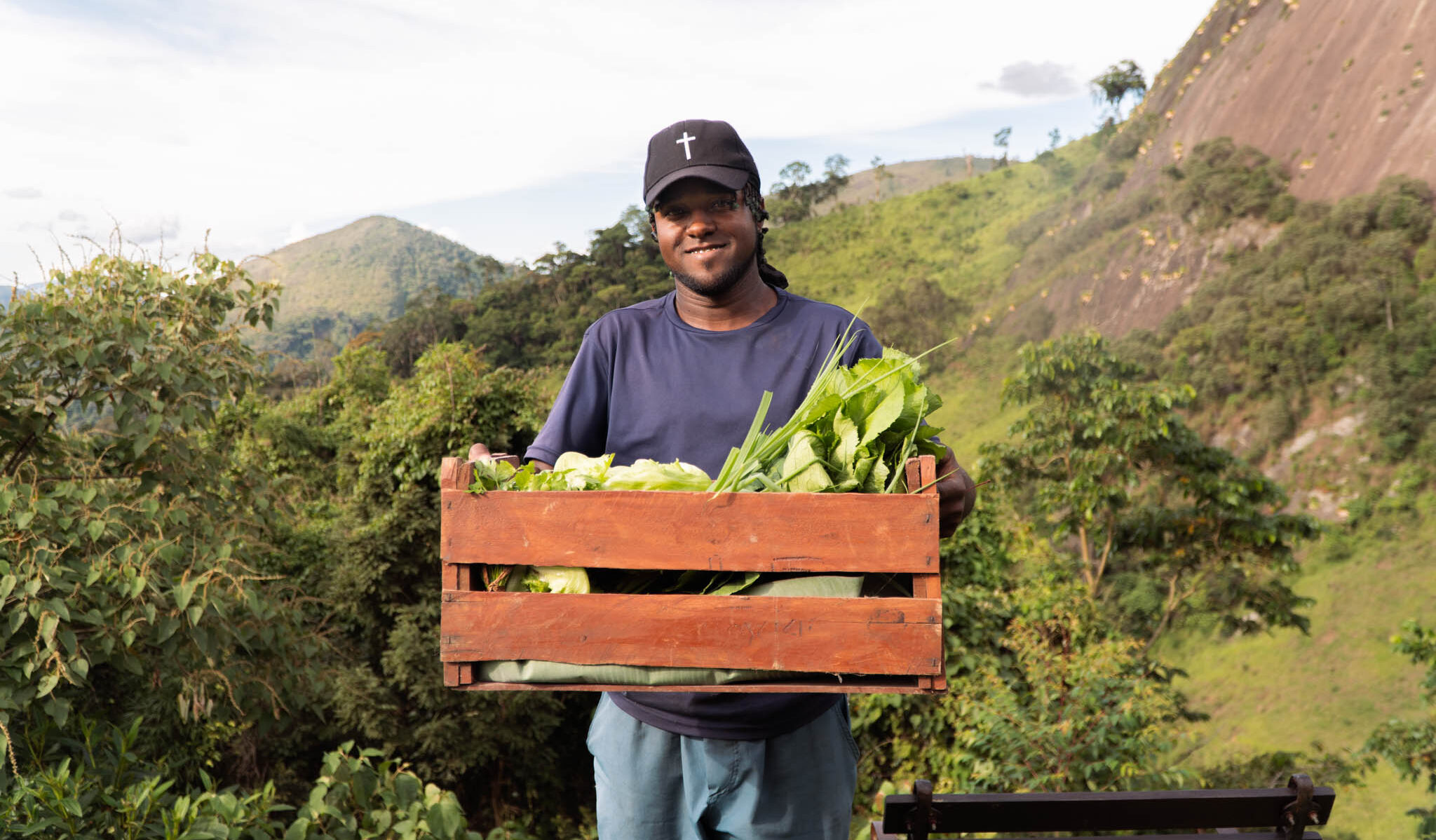 Farm worker carrying freshly harvested organic vegetables from an eco farm in Brazil.