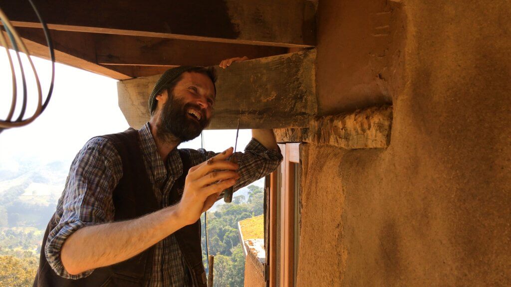 Volunteer building wall with natural materials in Eco farm