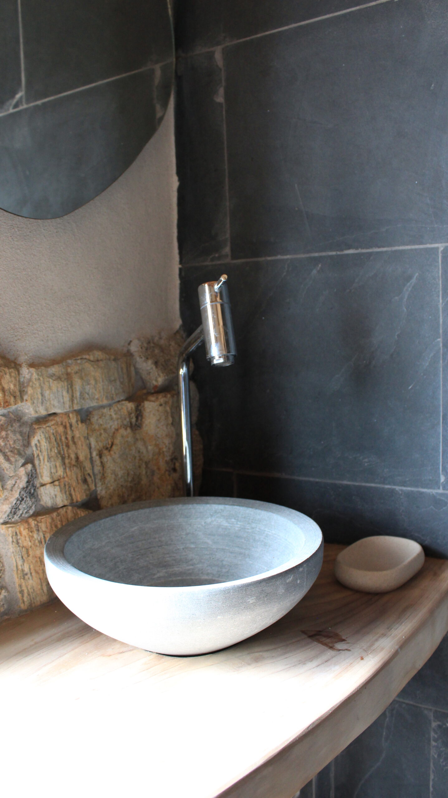 Modern bathroom with natural materials inside a sustainable bioconstruction house in Brazil