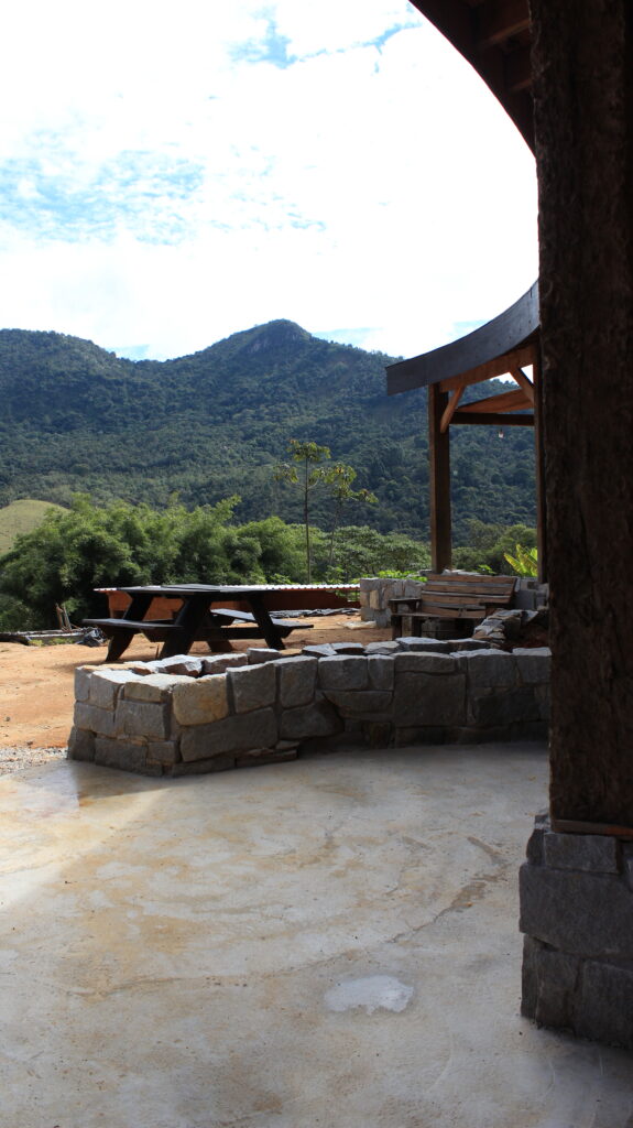 Beautiful sustainable kitchen and dining room with mountain view at an eco farm in Brazil