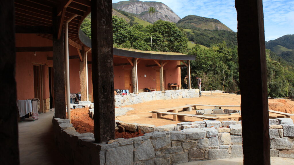 Eco house with grass roof and mountain landscape at a permaculture farm Brazil