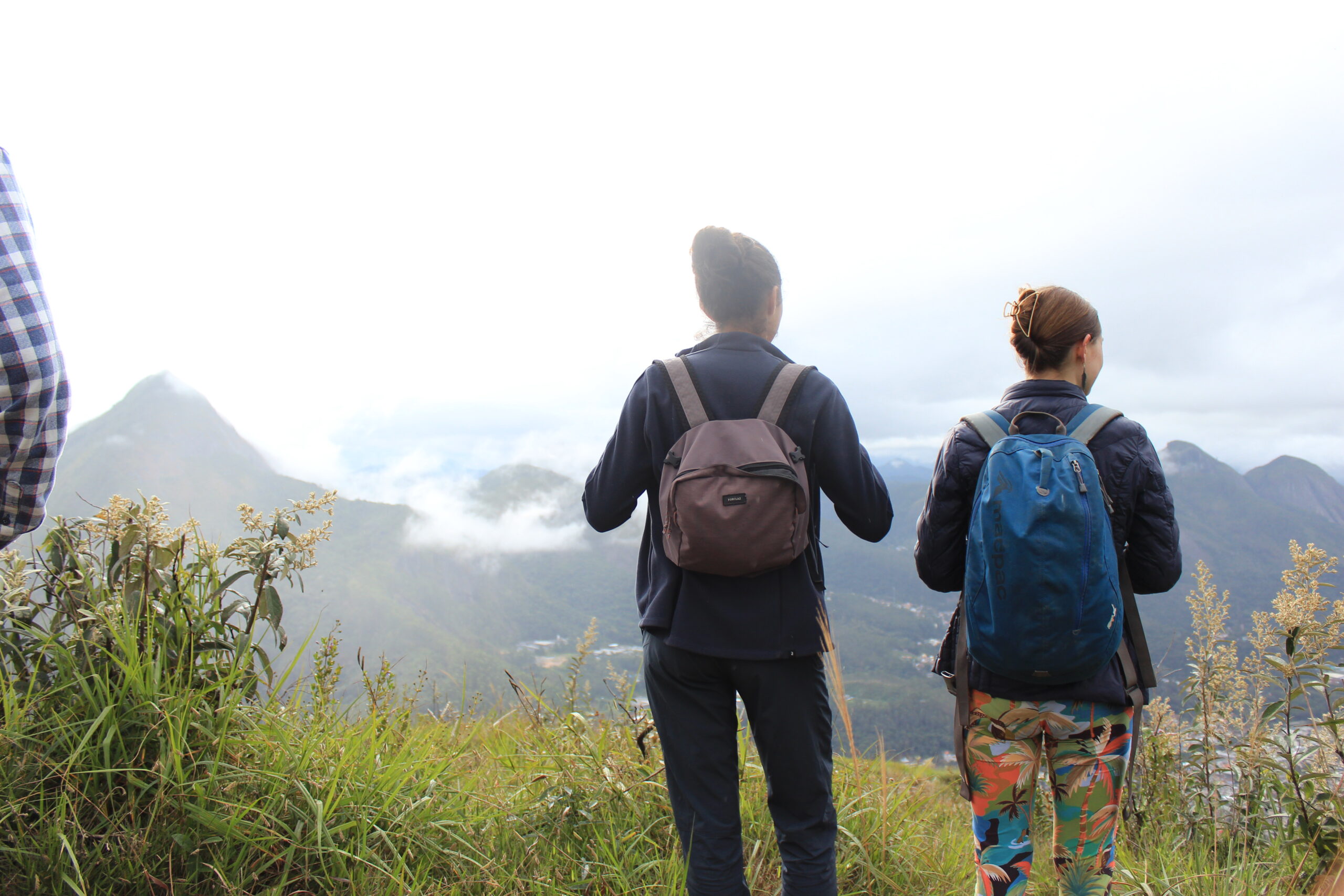 Volunteers admiring the mountain landscape during an ecotourism hiking experience in the Atlantic Forest, BrazilVolunteers admiring the mountain landscape during an ecotourism hiking experience in the Atlantic Forest, Brazil