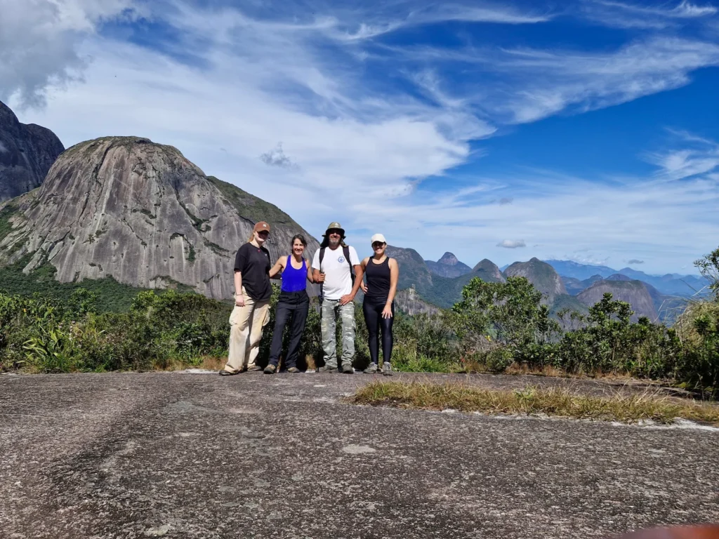 Volunteers posing for a group photo during a hiking trail in the Atlantic Forest, Brazil.