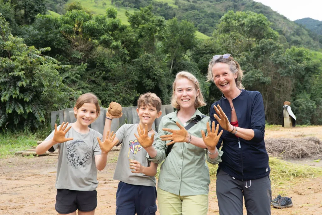 Family participating in a natural building workshop at an eco farm in Brazil.