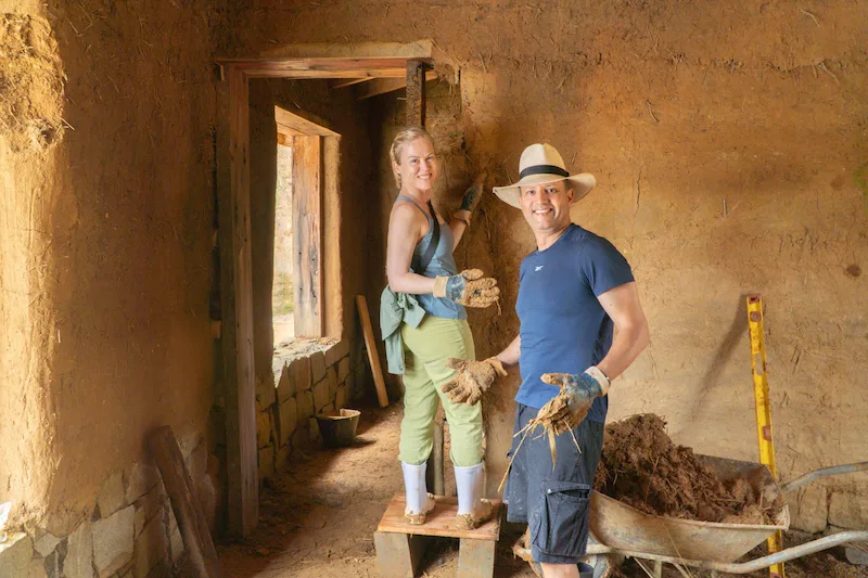 Volunteers constructing sustainable buildings using natural materials during a bioconstruction project in Brazil.